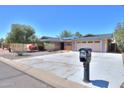 Charming one-story home with desert landscaping, a two-car garage, and a large driveway at 1220 E Avenida Ellena St, Casa Grande, AZ 85122