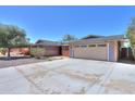 Lovely single-Gathering home featuring a two-car garage, desert landscaping, and solar panels at 1220 E Avenida Ellena St, Casa Grande, AZ 85122