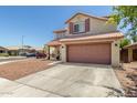 Charming two-story home features a well-maintained exterior, two-car garage, and lovely curb appeal at 1617 W Pecan Rd, Phoenix, AZ 85041