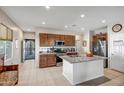 Spacious kitchen with a central island, stainless steel appliances, and ample cabinet space for storage at 17520 W Fairview St, Goodyear, AZ 85338