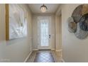 Welcoming entryway with stylish tile flooring, a decorative light fixture, and elegant wall art at 1776 E Laddoos Ave, Queen Creek, AZ 85140