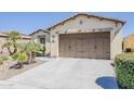 Attractive home featuring a well-maintained lawn, desert landscaping, and a spacious driveway at 1776 E Laddoos Ave, Queen Creek, AZ 85140