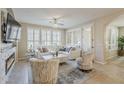 Bright living room with fireplace, white furniture, shuttered windows, and elegant decor at 1776 E Laddoos Ave, Queen Creek, AZ 85140