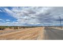 New street and lot ready to be built on with views of the desert landscape in the background at 18253 W Camino De Oro --, Surprise, AZ 85387