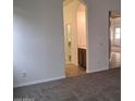 Bedroom view with fresh carpet and access to a bathroom at 18447 W Verdin Rd, Goodyear, AZ 85338