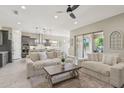 Bright living room features comfortable seating and an open layout with access to the patio at 18530 E Mockingbird Ct, Queen Creek, AZ 85142