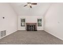 Bright living room featuring vaulted ceilings, cozy fireplace and carpet at 1918 S Shannon Dr, Tempe, AZ 85281