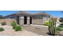 Exterior view of home featuring desert landscaping, an arched entryway, and a mature Saguaro cactus in the yard at 20838 E Vía De Arboles --, Queen Creek, AZ 85142