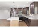 Modern kitchen featuring stainless steel appliances, a center island, and stylish cabinetry at 2329 S Elm --, Mesa, AZ 85202