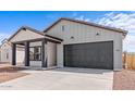 Attractive home with a two-car garage, covered porch, tidy landscaping, and a modern design at 23385 W Burton Ave, Buckeye, AZ 85326