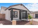 Cozy single-Gathering home with a charming front porch and a well-maintained yard and a two-car garage at 23385 W Burton Ave, Buckeye, AZ 85326