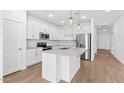 Bright kitchen featuring white cabinets, quartz countertops, stainless steel appliances, and a center island at 23385 W Burton Ave, Buckeye, AZ 85326