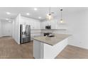 Modern kitchen featuring stainless steel appliances, a central island, and stylish pendant lighting at 23456 W Fulton St, Buckeye, AZ 85326