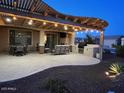 Outdoor patio showcasing a pergola with decorative lighting and an outdoor kitchen at 27021 W Kerry Ln, Buckeye, AZ 85396