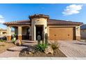 Attractive single-story home boasting a desert-themed front yard and neutral color palette at 27021 W Kerry Ln, Buckeye, AZ 85396