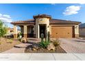 Inviting residence with a well-maintained front yard showcasing desert flora and paved driveway at 27021 W Kerry Ln, Buckeye, AZ 85396