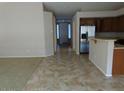 Open-concept area with tile floors leading to a kitchen with stainless steel appliances at 29797 W Mitchell Ave, Buckeye, AZ 85396
