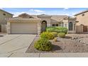 Charming single-story home with a well-manicured desert landscape and a two-car garage at 300 W Windsor Dr, Gilbert, AZ 85233