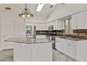 Well-lit kitchen featuring white cabinets, granite countertops, and stainless steel appliances at 300 W Windsor Dr, Gilbert, AZ 85233