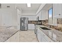 Bright kitchen with granite countertops, stainless steel appliances, and a tile backsplash at 300 W Windsor Dr, Gilbert, AZ 85233