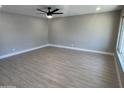 Bright living room featuring hardwood flooring, neutral walls, modern ceiling fan, and trim work at 3538 W Sierra Vista Dr, Phoenix, AZ 85019