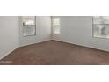 A clean and simple bedroom with carpet and three windows at 35397 N Shorthorn Trl, San Tan Valley, AZ 85143