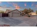 Tan home with a two car garage and desert landscaping in front on a paved street at 3842 W Ironwood Dr, Chandler, AZ 85226