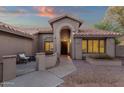 Inviting front entrance featuring a decorative door, desert landscaping, and a cozy seating area at 3842 W Ironwood Dr, Chandler, AZ 85226