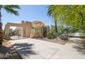 Side view of stucco home featuring desert landscaping and a concrete driveway surrounded by mature trees at 39 E Hoover Ave, Phoenix, AZ 85004