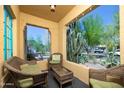 Inviting covered front porch featuring comfortable wicker seating and views of lush desert landscaping at 39 E Hoover Ave, Phoenix, AZ 85004
