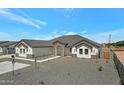Charming single-story home with a well-manicured yard, a gray tile roof and a stone entryway at 3989 E Freeman Ln, San Tan Valley, AZ 85140
