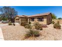 Well maintained single-story home with desert landscaping and shutters on windows at 40264 W Lococo St, Maricopa, AZ 85138