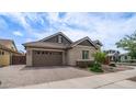 Lovely one-story home showcasing a brick driveway, two car garage, and appealing architectural details at 4323 E Wheaton St, Gilbert, AZ 85295