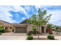 Inviting single-Gathering house boasts manicured landscaping, a paved driveway, and a two-car garage at 4323 E Wheaton St, Gilbert, AZ 85295