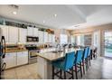 Bright eat-in kitchen featuring granite countertops, white cabinetry, stainless steel appliances, and a large island at 514 E Yvonne Ln, Tempe, AZ 85284