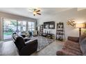 Comfortable living room with a ceiling fan, TV, tile flooring and sliding door access to the backyard at 514 E Yvonne Ln, Tempe, AZ 85284