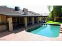 Backyard pool, patio, and covered area offers space for outdoor entertainment and relaxation at 6372 W Redfield Rd, Glendale, AZ 85306