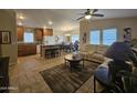 Spacious living area showcasing an open floorplan with a large rug and natural light at 650 N Hawes Rd # 4007, Mesa, AZ 85207