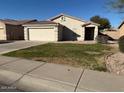 This home features a two-car garage, front lawn, and desert landscaping at 7232 W Zak Rd, Phoenix, AZ 85043