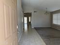 Inviting entryway showcases tile flooring transitioning to carpeted living spaces at 7266 E Monte Ave, Mesa, AZ 85209