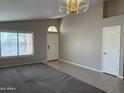 Spacious living room with neutral walls, a ceiling fan, and natural light at 7266 E Monte Ave, Mesa, AZ 85209