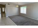 Bright living room featuring neutral walls, carpet, and a window with natural light at 7266 E Monte Ave, Mesa, AZ 85209