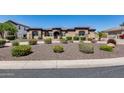 Beautiful single-Gathering home with a stone facade, manicured landscaping, and a circular driveway at 8024 W Vista Ave, Glendale, AZ 85303