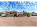 Exterior of a single-story home with desert landscaping and partial shade covering a portion of the patio at 930 E Friar Ave, Apache Junction, AZ 85119