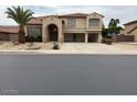 Charming two-story home featuring an arched entrance and a spacious three-car garage at 9556 W Blue Sky Dr, Peoria, AZ 85383