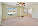 Bright living room with large window, neutral walls, and open floor plan at 9635 W Ironwood Dr # B, Peoria, AZ 85345