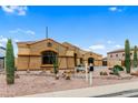 Single-story home boasting desert landscaping, mature cacti, and private driveway at 10040 E Grandview St, Mesa, AZ 85207