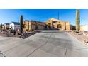Charming single-Gathering home featuring a desert landscape, a spacious driveway, and an attached three-car garage at 10040 E Grandview St, Mesa, AZ 85207