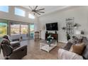 Bright and airy living room featuring a large window, a ceiling fan, and comfortable seating at 10040 E Grandview St, Mesa, AZ 85207