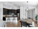 Modern kitchen featuring dark cabinets, granite countertops, and stainless steel appliances at 10714 E Lincoln Ave, Mesa, AZ 85212